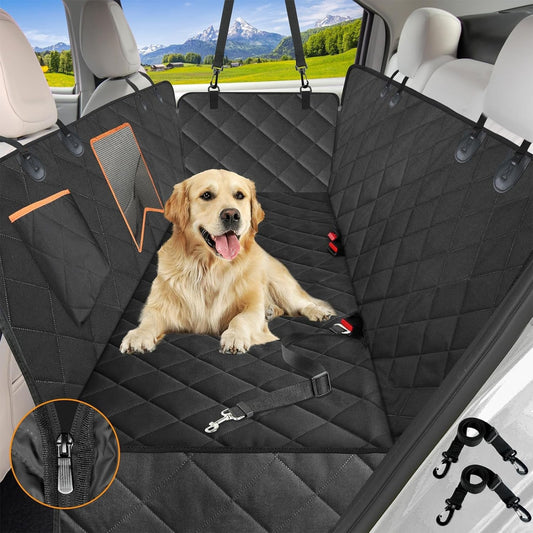 Dog sitting on a black car seat cover with a scenic view outside.